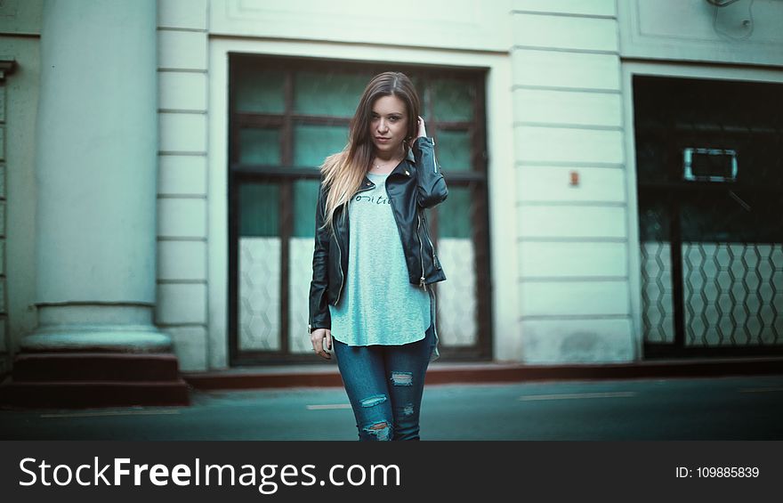 Woman in Gray Printed Shirt With Black Leather Jacket and Black Distressed Jeans