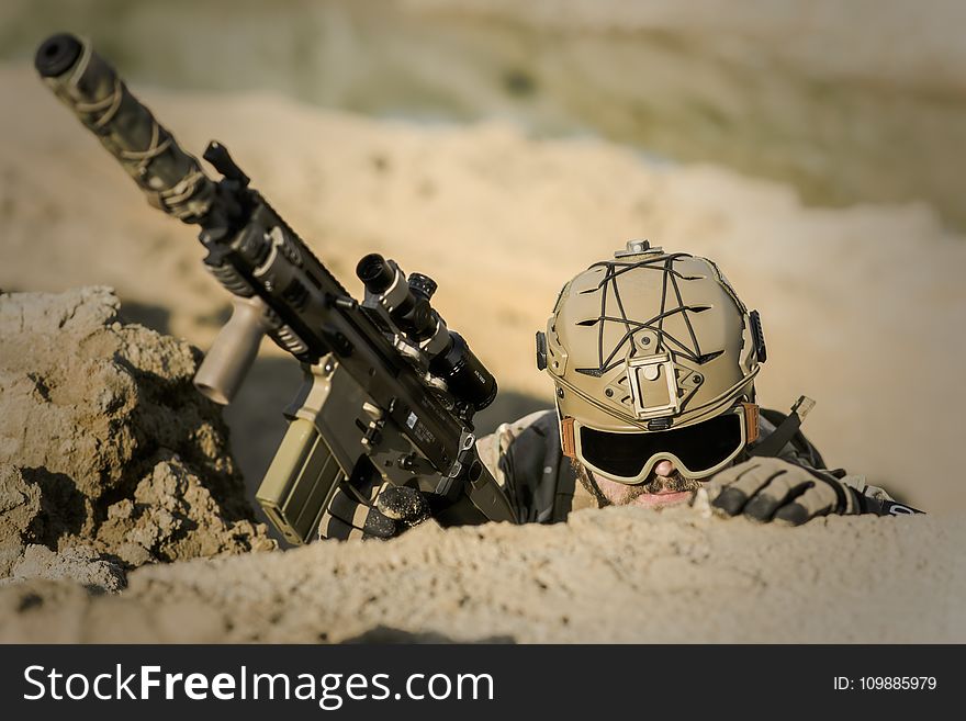 Soldier Wearing Brown Helmet Holding Assault Rifle during Daytime