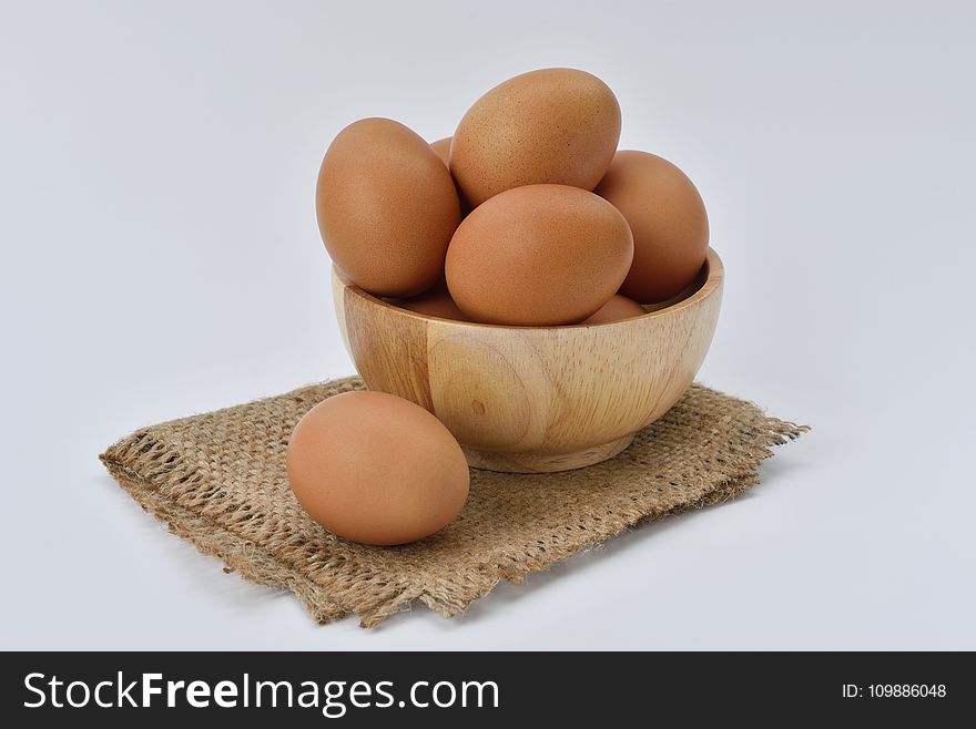 Brown Eggs on Brown Wooden Bowl on Beige Knit Textile