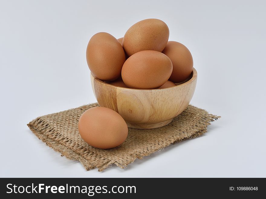 Brown Eggs On Brown Wooden Bowl On Beige Knit Textile