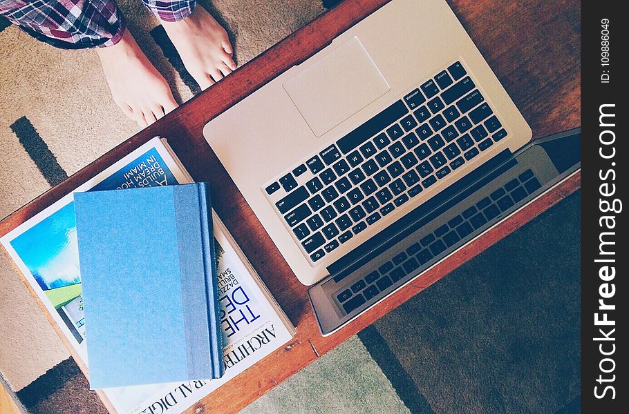 Macbook Air Beside 2 Books on Table