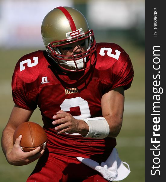 Man in Red Football Field during Daytime