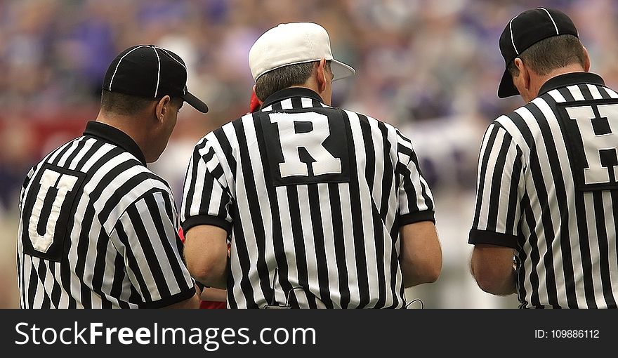 3 Referees Standing on Field