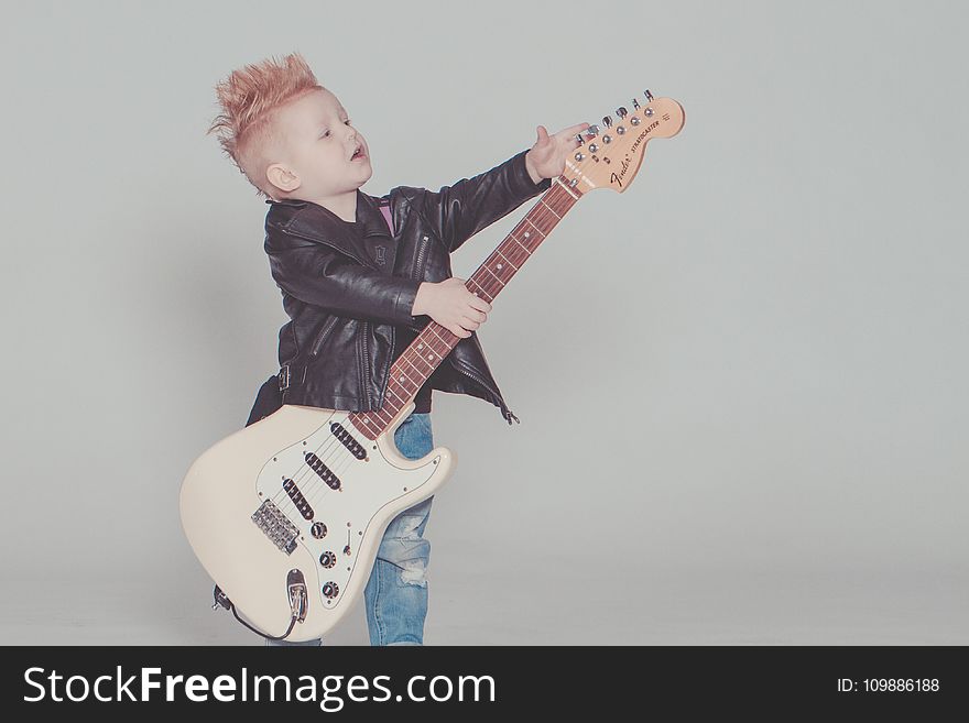 Boy Wearing Black Jacket Holding Electric Guitar