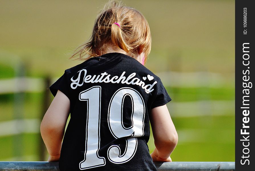 Girl Wearing Deutschland 19 Black T Shirt During Daytime