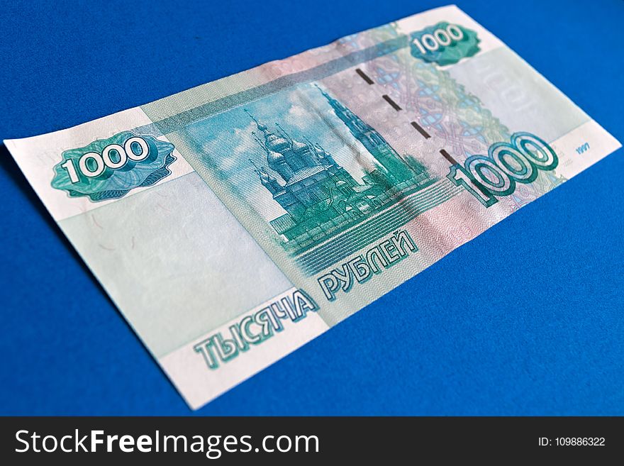 1000 Banknote on Top of Blue Surface