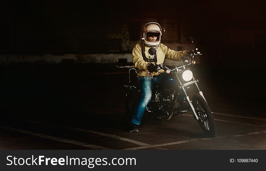 Man Wearing White Full Face Helmet Riding On Standard Motorcycle