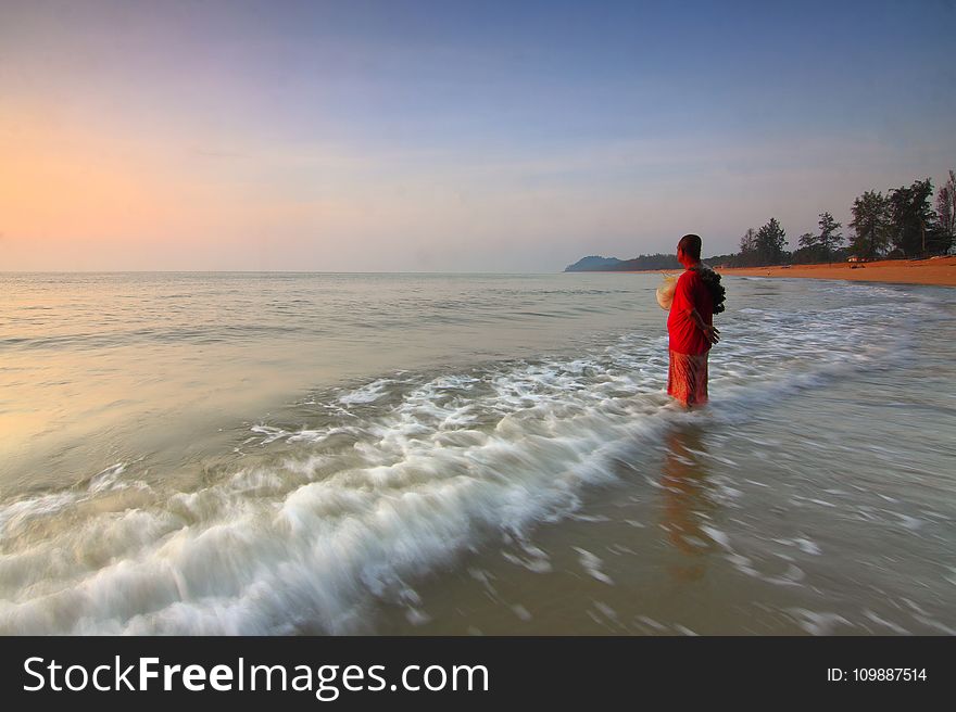 Person On The Seashore During Sun Set