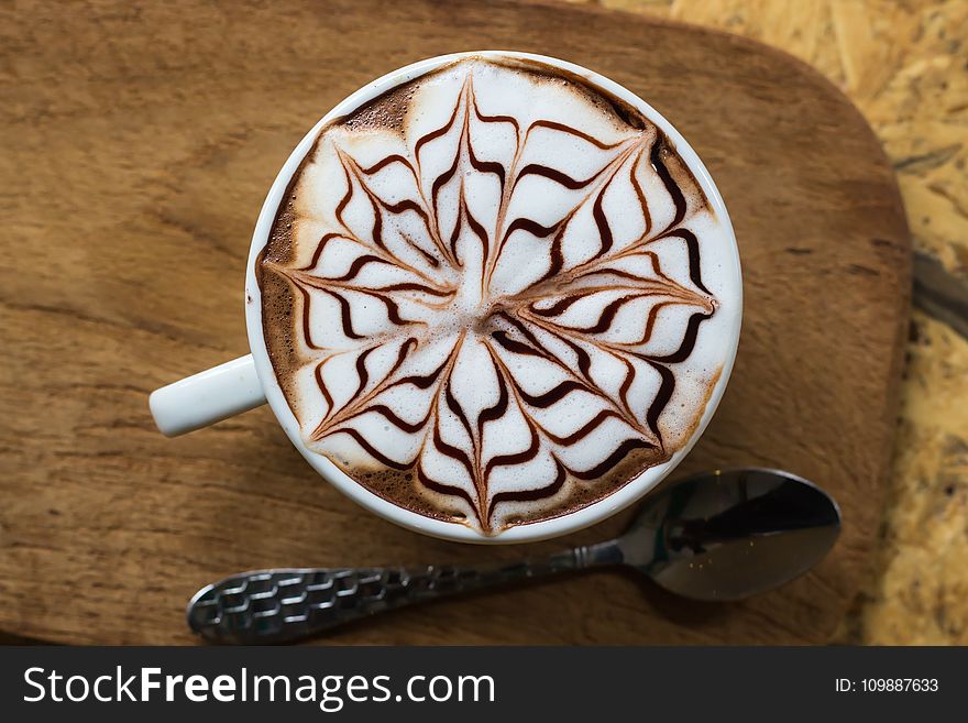 Brown and White Coffee With Floral Art in White Ceramic Mug