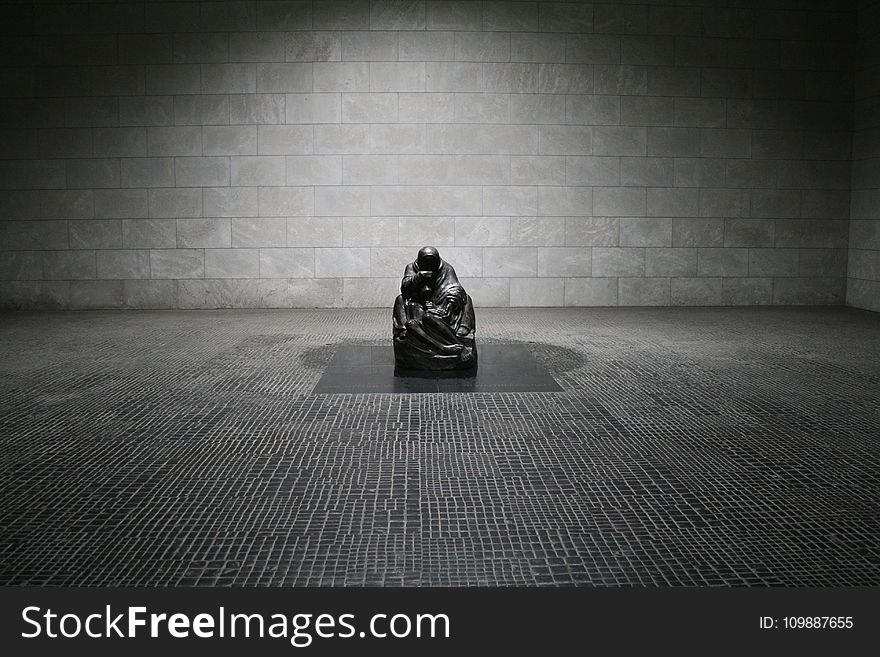 Man In Monk Suit Sitting