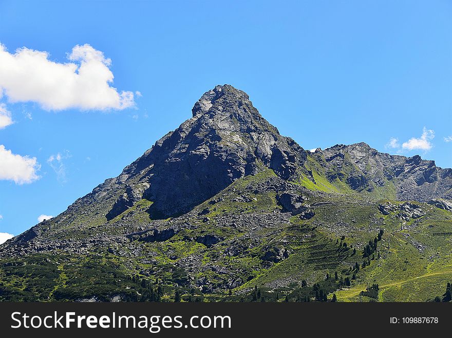 Gray Mountains Covered by Green Trees Under Clear Blue Sky and Clouds