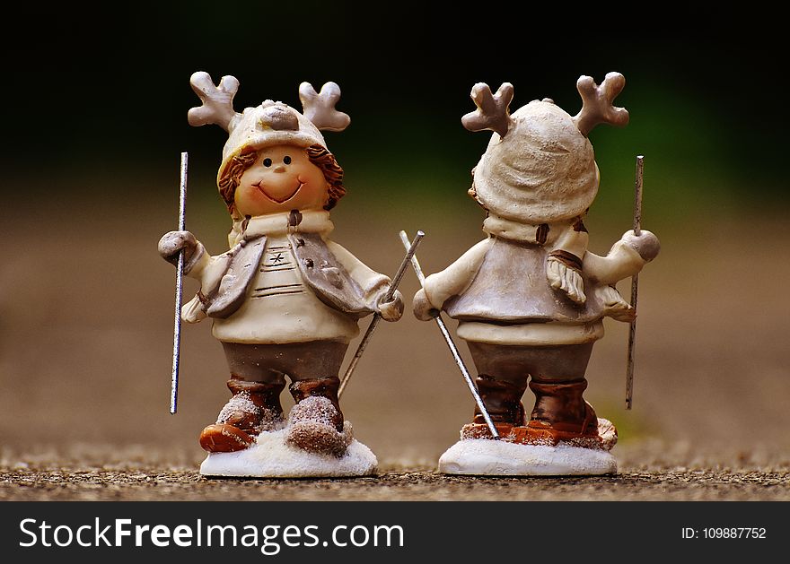 Beige and Brown Boy Skiing Figurine