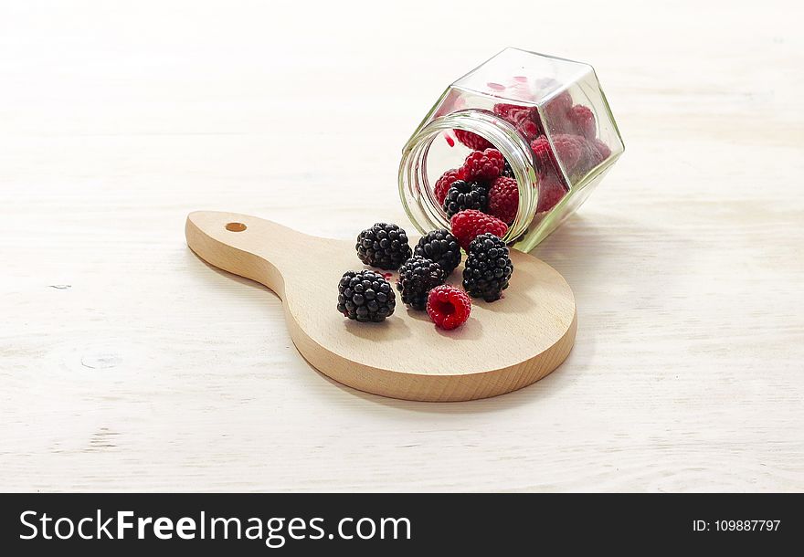 Clear Glass Bottle With Raspberries Inside