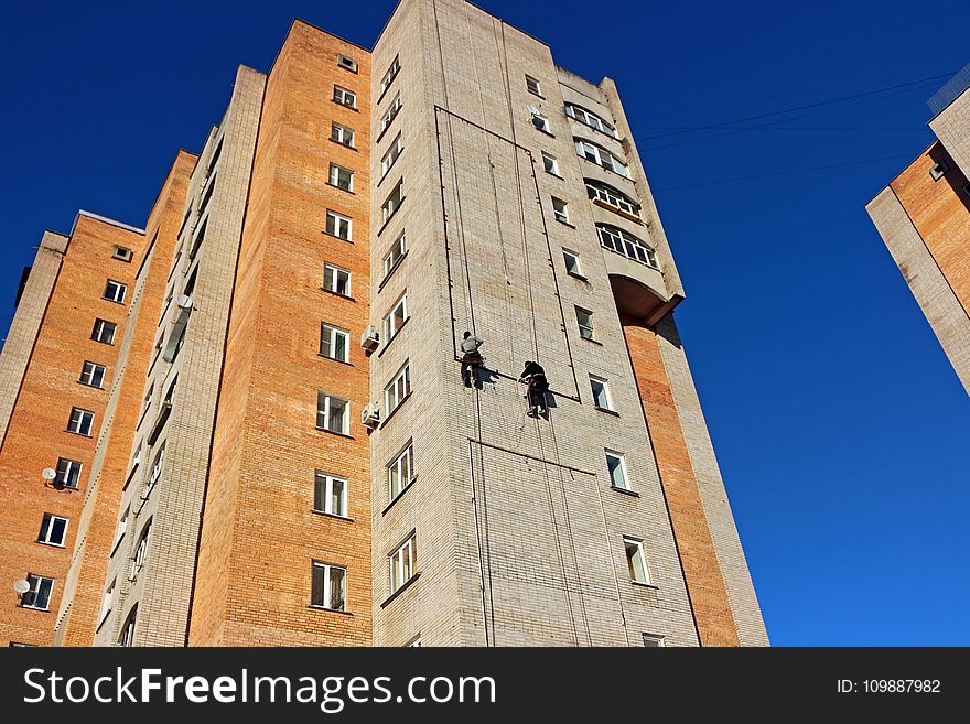 Person Hanging on a High Rise Building