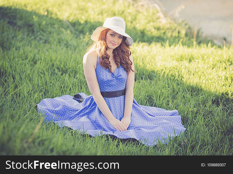 Portrait Of A Smiling Young Woman In Grass