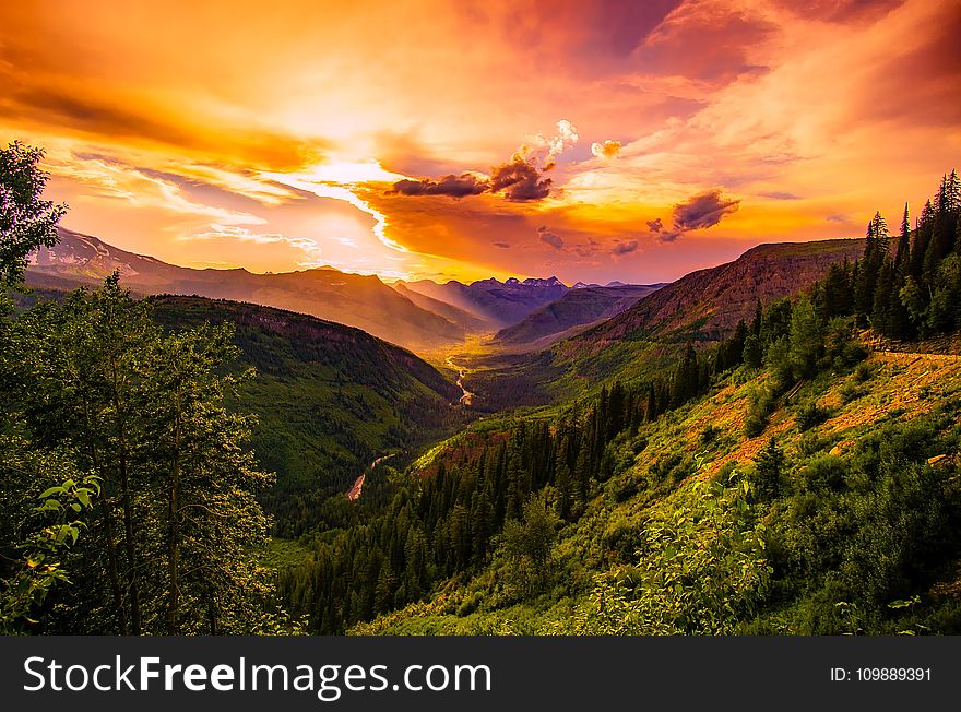 Green Mountain Near River Under Cloudy Sky during Daytime