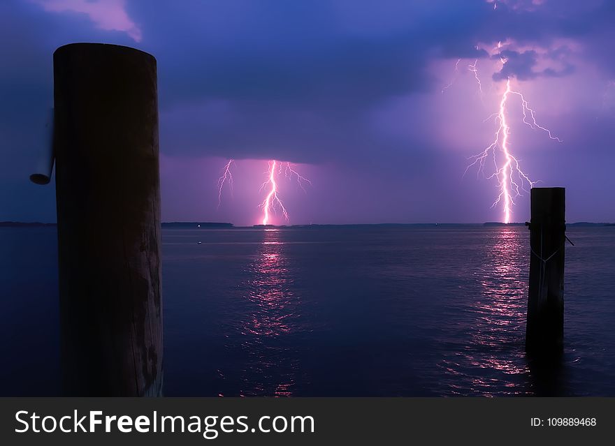 Lightning Over Sea Against Storm Clouds