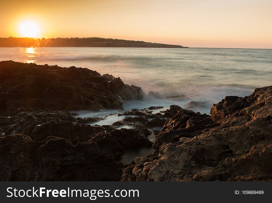 Scenic View Of Sea Against Dramatic Sky During Sunset