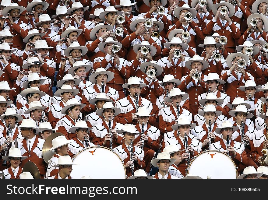 Group of People in White Hat Playing Together Different Kinds of Musical Instruments