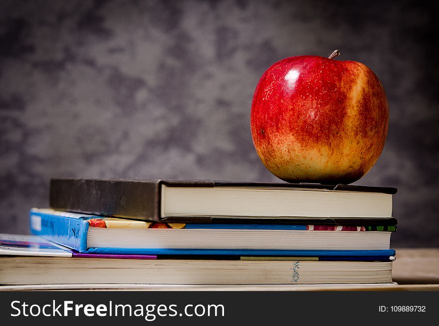 Close-up of Apple on Top of Books