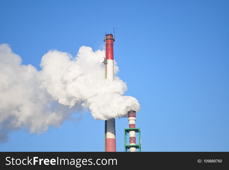 Smoke Stacks Against Blue Sky