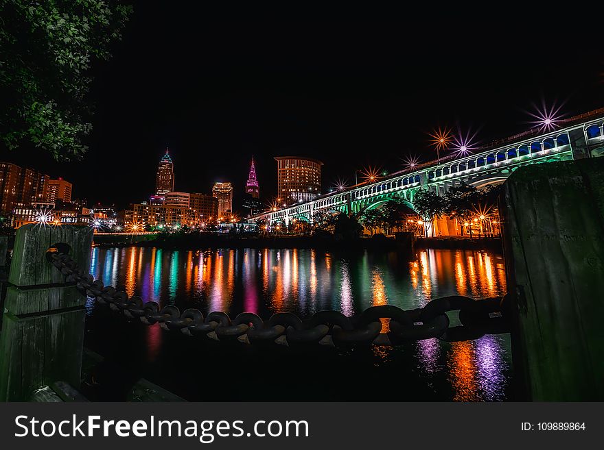 Reflection Of Illuminated Buildings In Water At Night