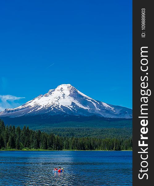 Scenic View of Lake Against Mountain Range