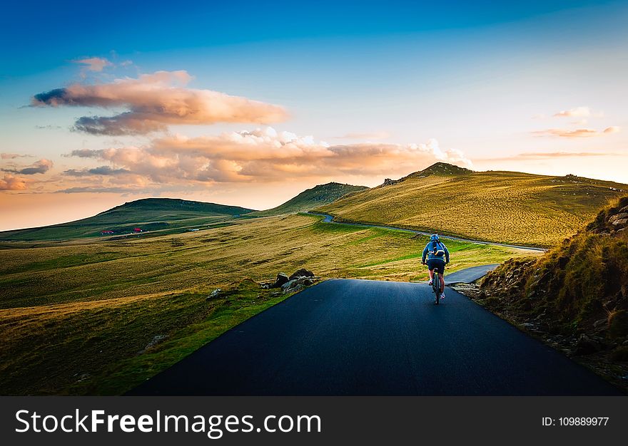 Rear View of Man on Mountain Road Against Sky