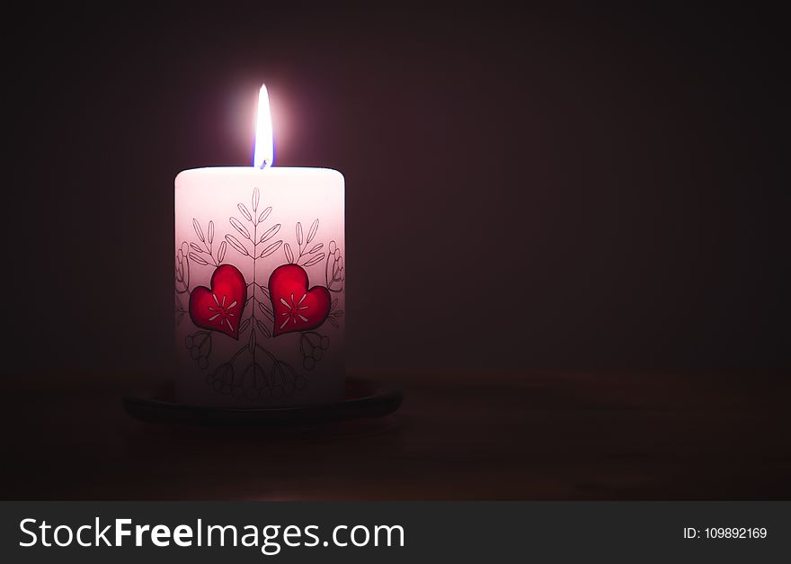 Close-up of Illuminated Candle Against Black Background