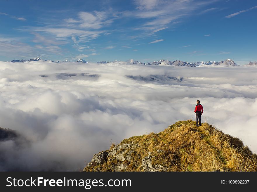 Man Standing on Mountain Against Sky