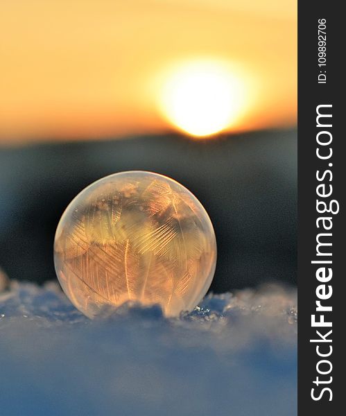 Frozen Soap Bubble Against Sky During Sunset