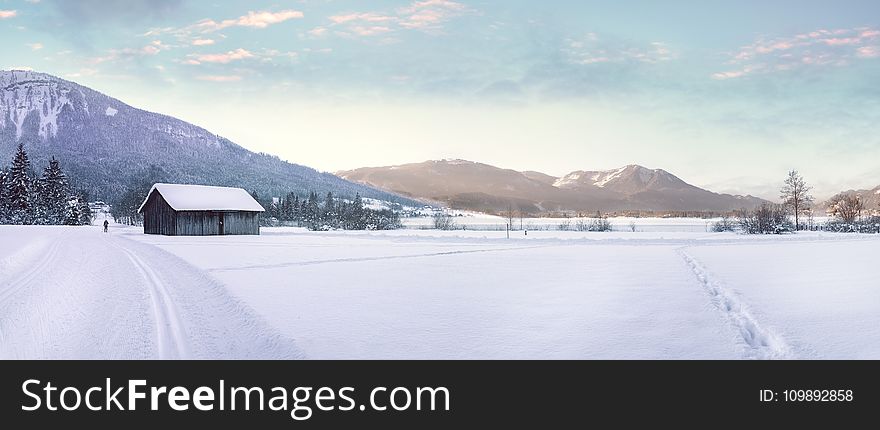 Snow Covered Landscape Against Mountain Range