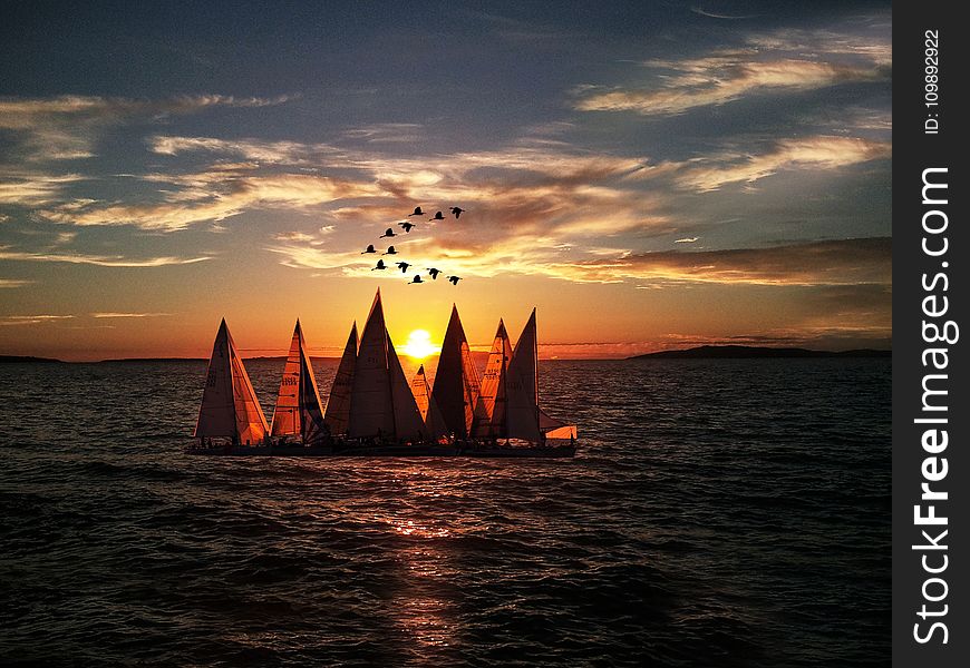 Sailboats Sailing On Sea During Sunset