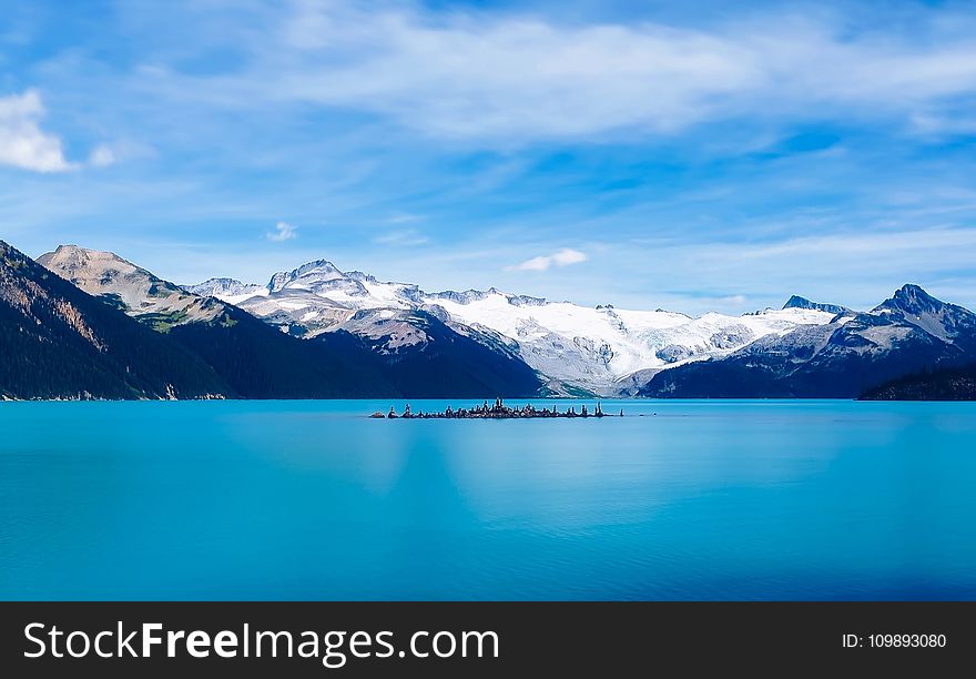Scenic View of Frozen Lake Against Mountain Range