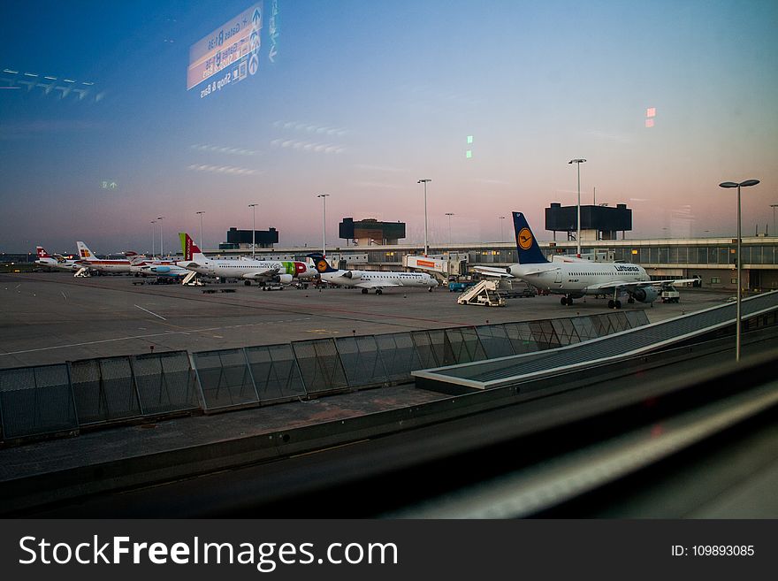 Airplanes on Hangar Under Blue Sky