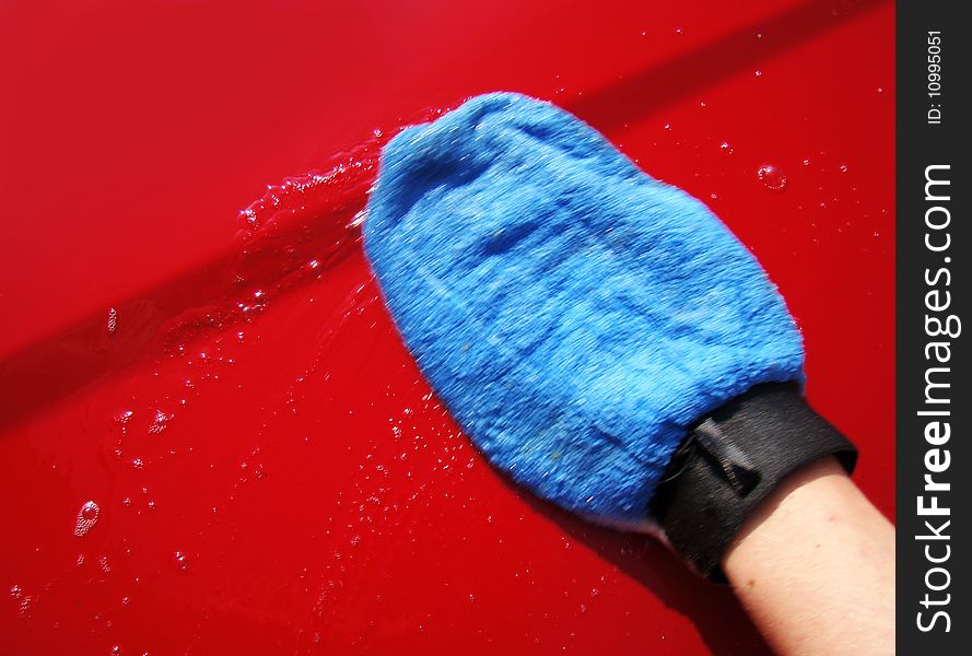 Washing the car with soap and quality blue glove. Washing the car with soap and quality blue glove.