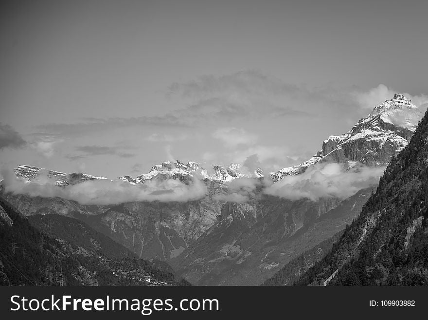 Snow Covered Rugged Mountain With Mist Photograph