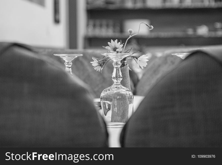 Upside Down Wine Glass Behind the Flower Grayscale Photo