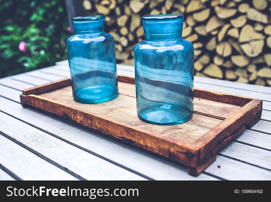 Two blue jars on the wooden tray