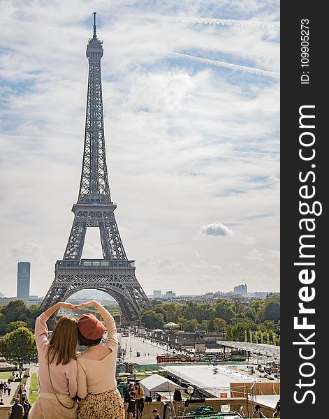 Photo of Two Women Posing in Front of Eiffel Tower, Paris, France during Day Time