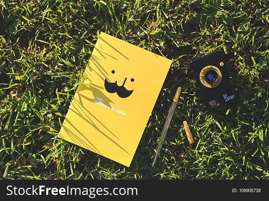 Yellow notebook on the grass