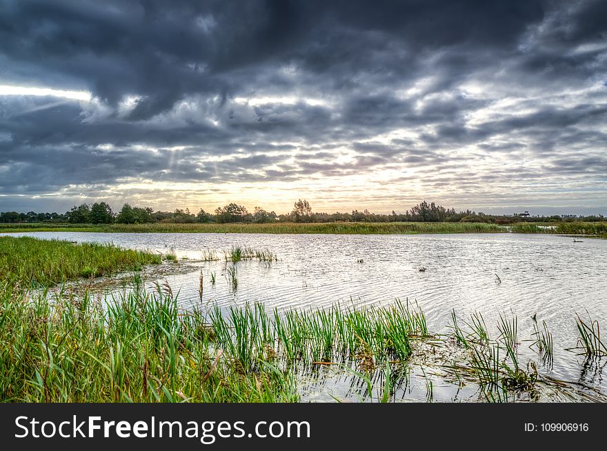 Photo of Body of Water Under Black Clouds