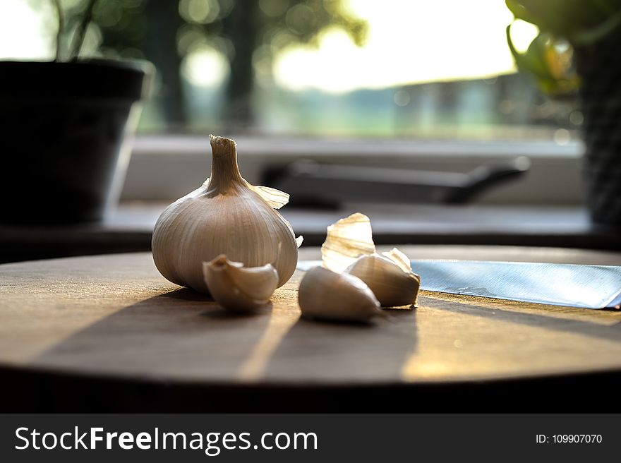 Photography of Garlic on Wooden Table
