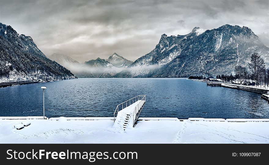 Dock Covered With Snow Near Lake