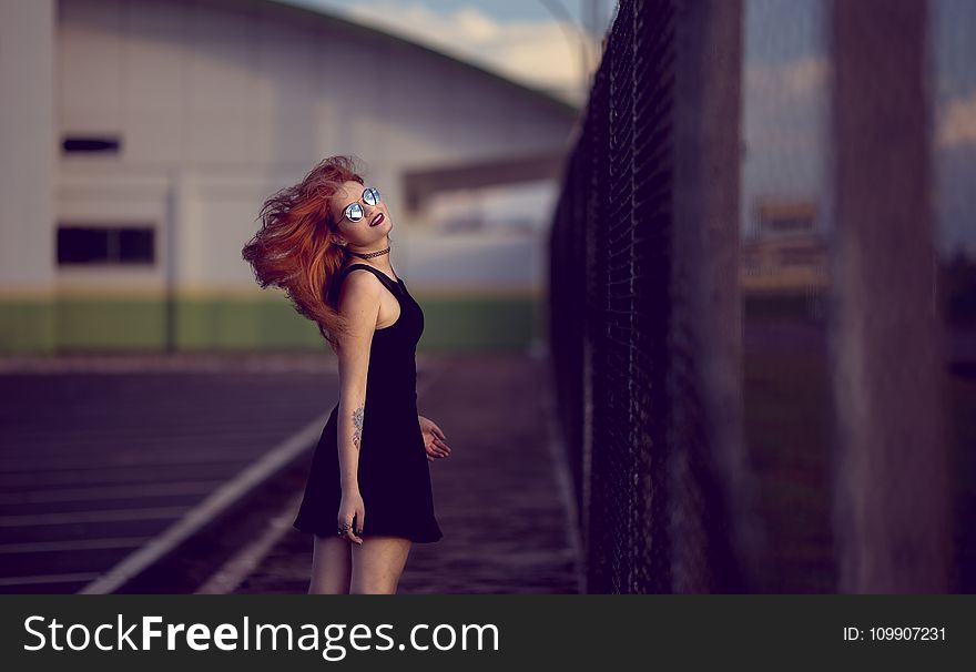 Shallow Focus Photo of Woman in Black Dress