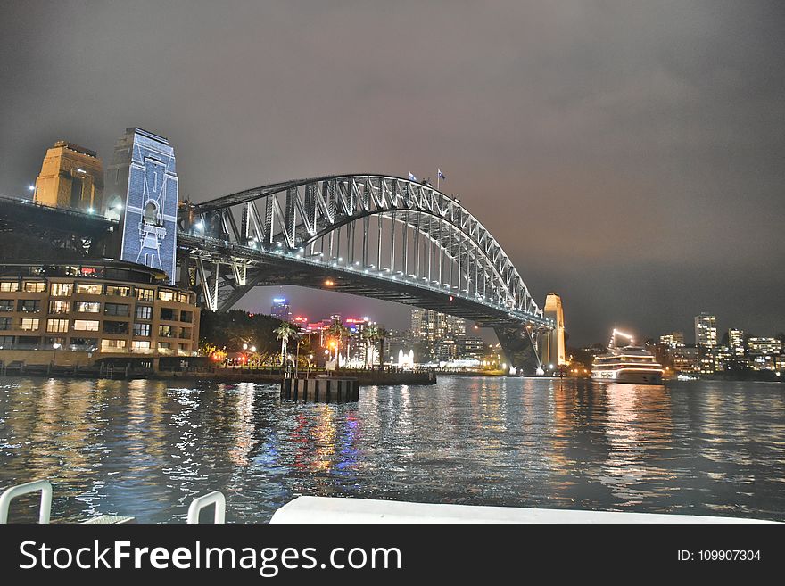 Bridge Under Grey Cloudy Sky During Nighttime