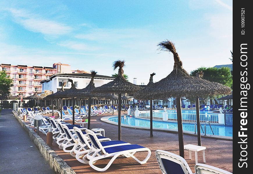 White Plastic Beach Loungers Near Pool at Daytime