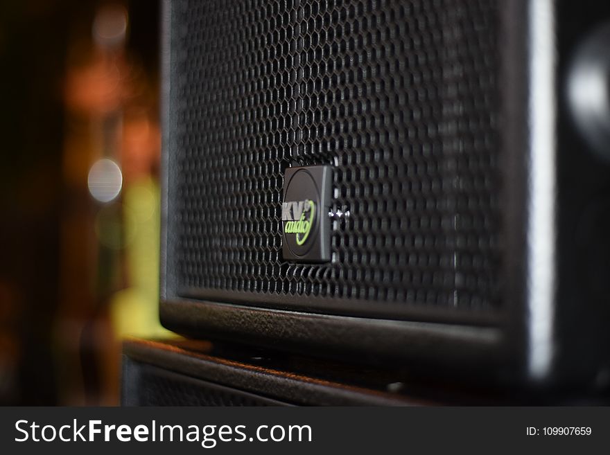 Black Speaker On Brown Wooden Stand