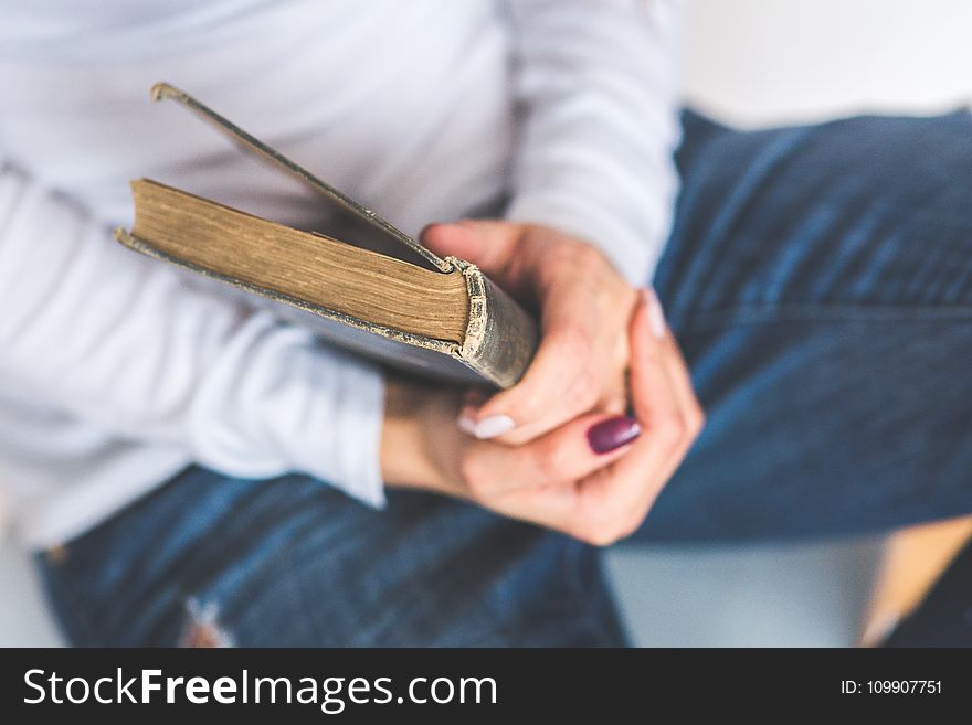 Girl Holding An Old Closed Book