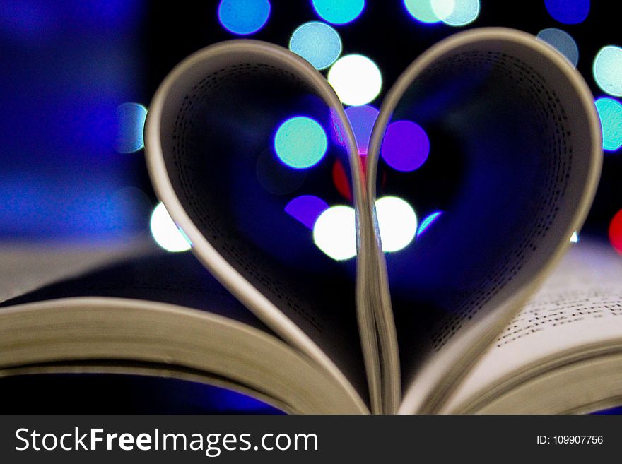 Photo of Bookpages Folded Into Heart Shape With Bokeh Light Background